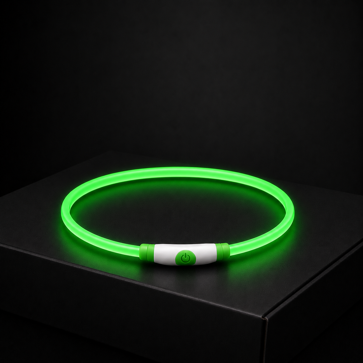 Green LED dog collar on a black surface with a dark background