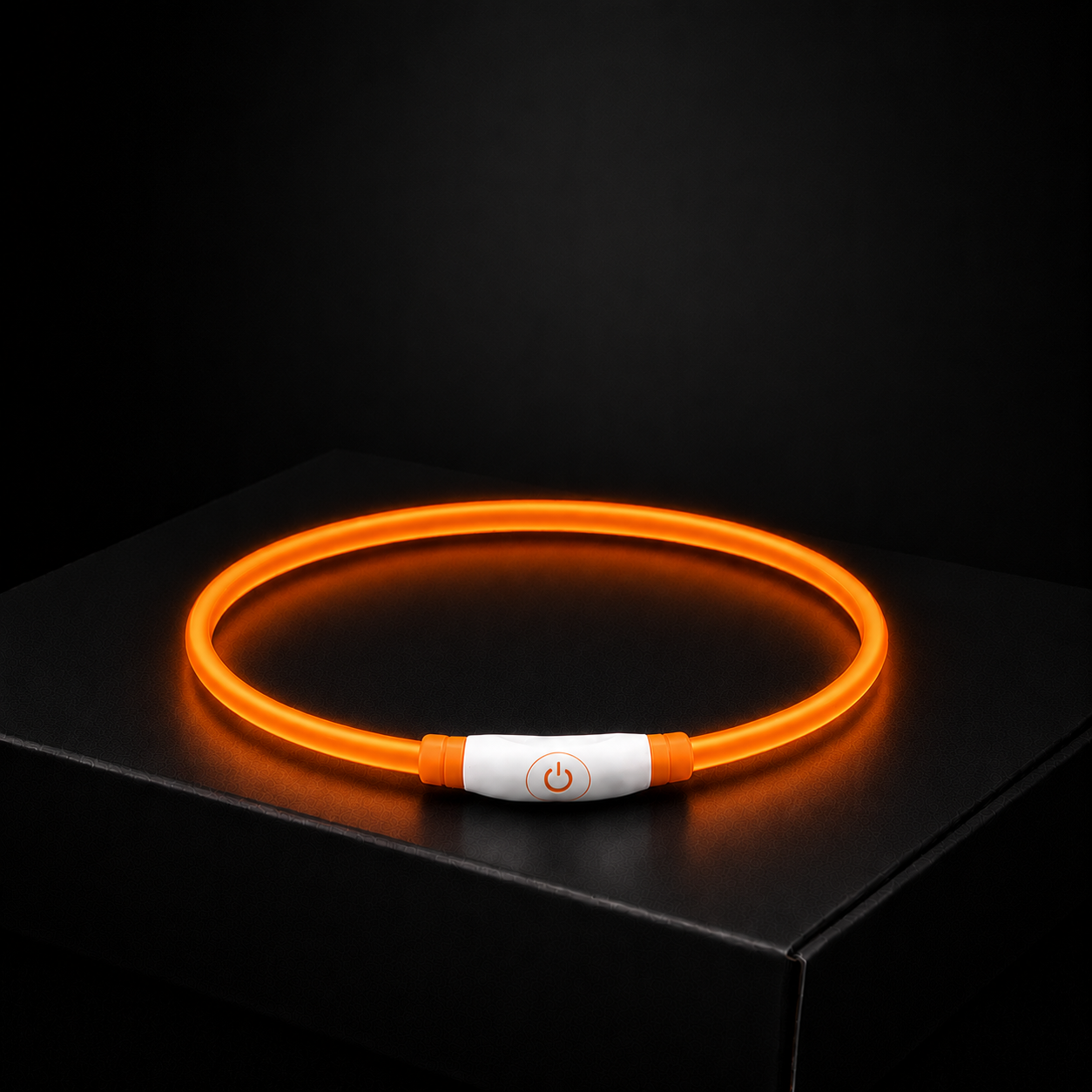 Glowing orange LED dog collar on a black background