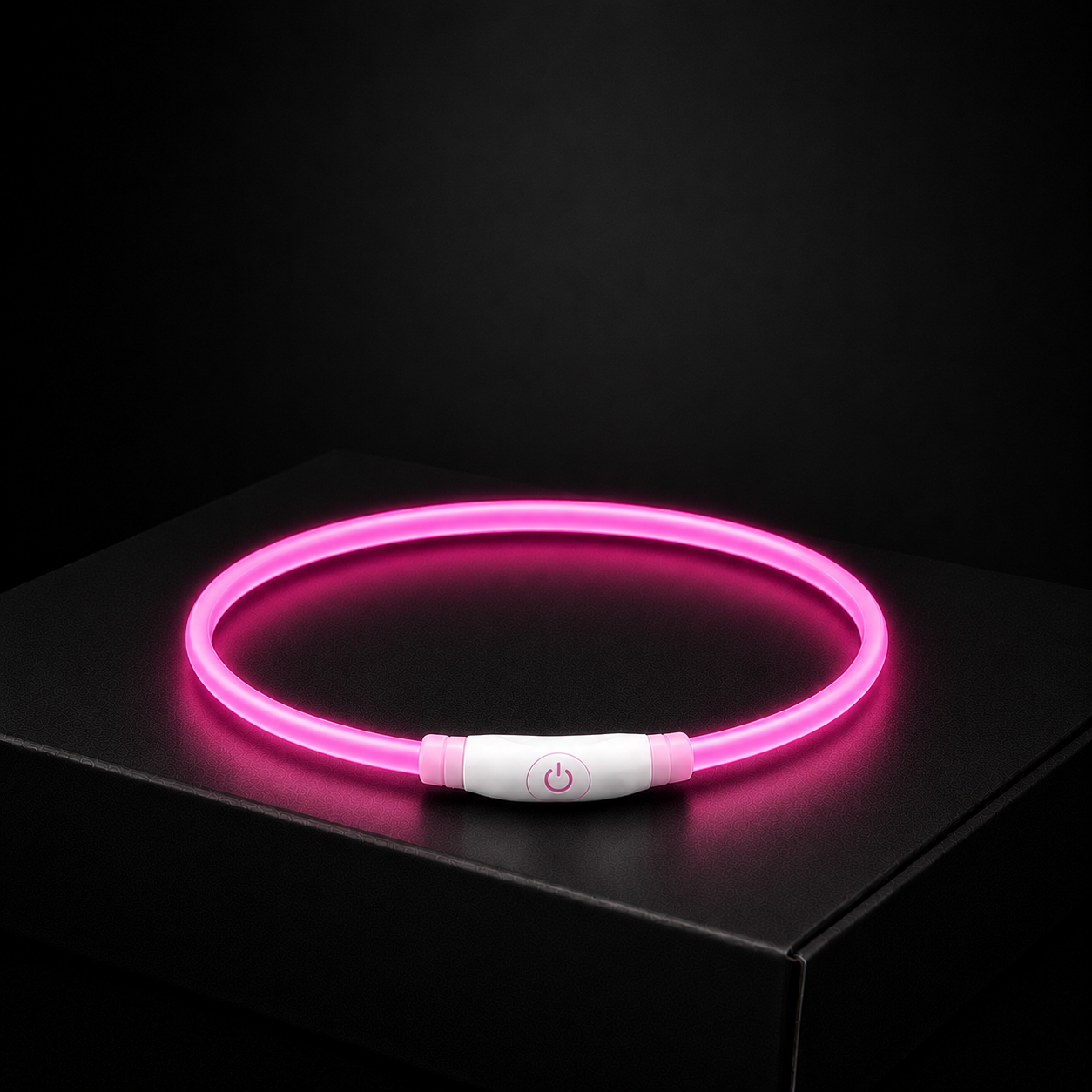 Pink LED dog collar on a black background