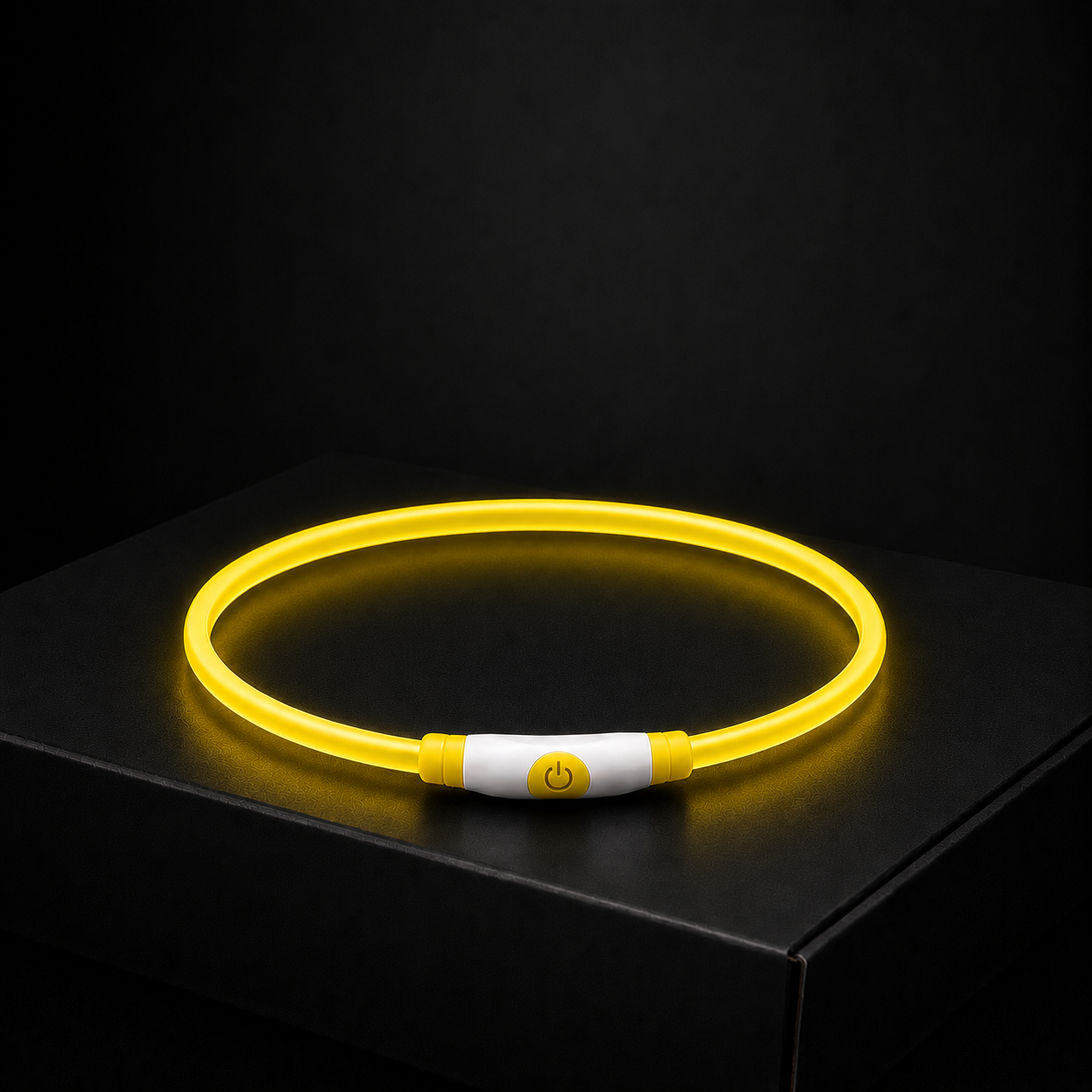 Glowing yellow dog collar on a black background